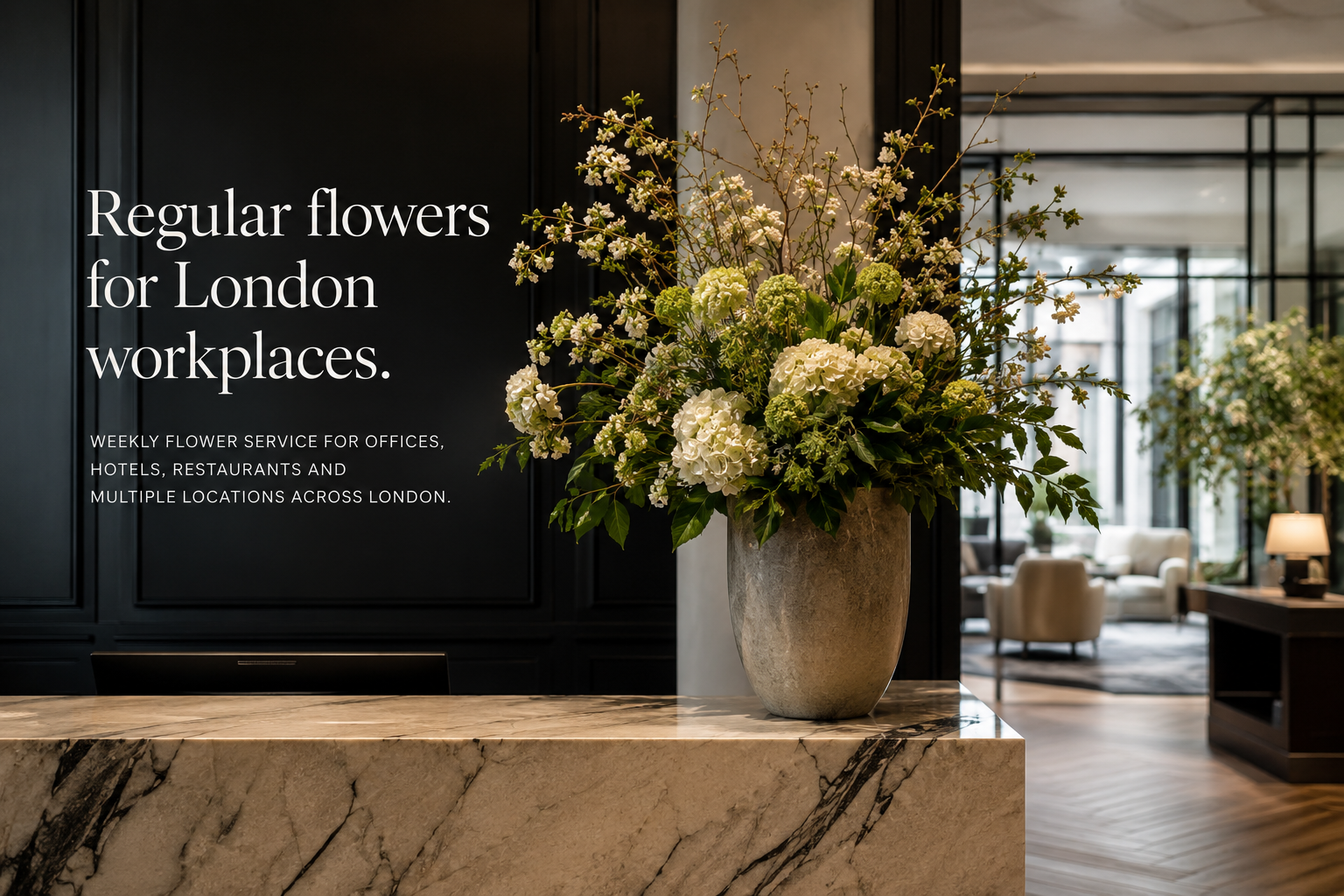 A large floral arrangement in a textured beige vase sits on a marble counter in a modern interior. White text on the left reads, 'Regular flowers for London workplaces.