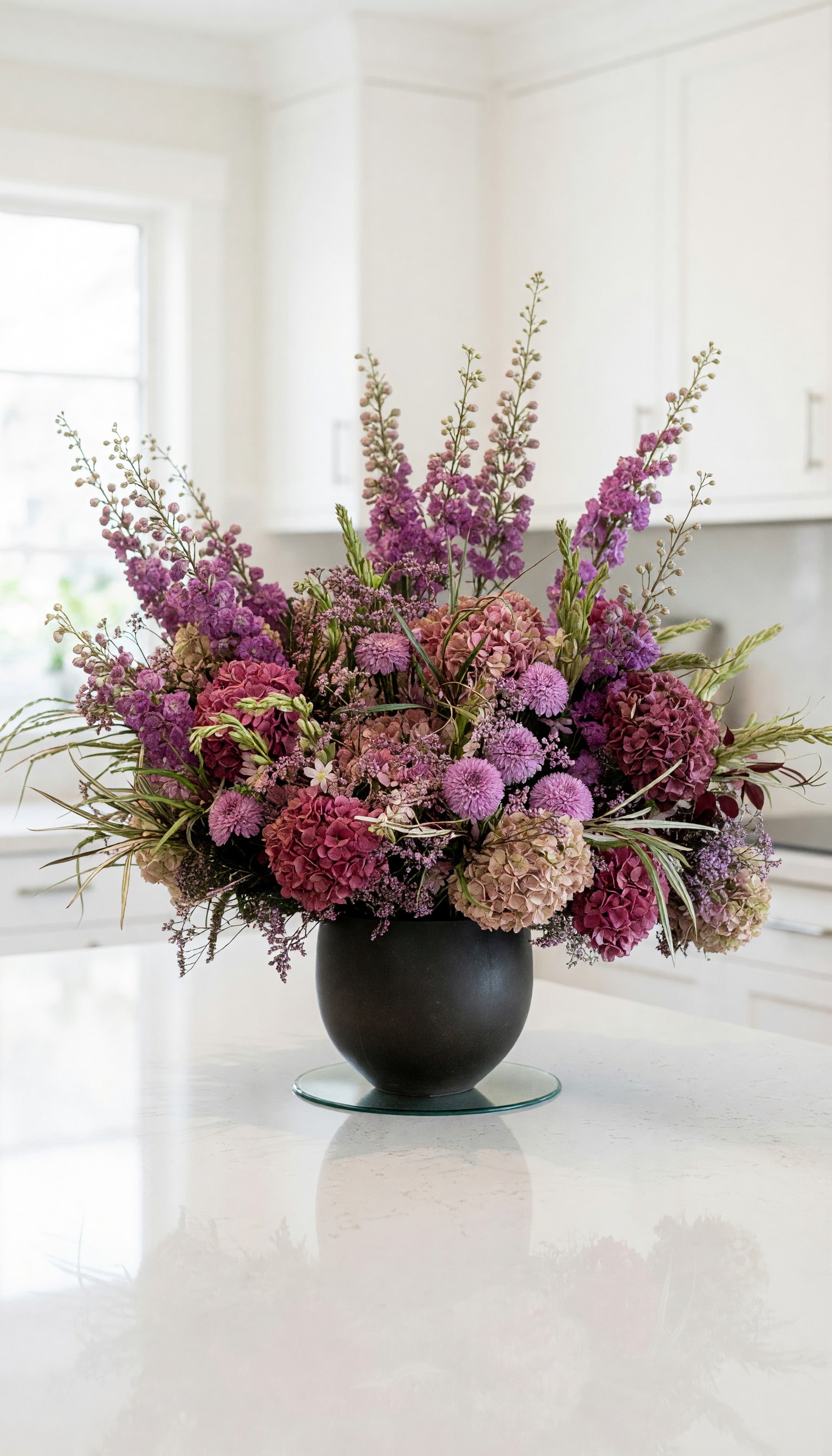 Luxury Primrose Hill flower bouquet  with pink hydrangeas and seasonal flowers in a London kitchen 