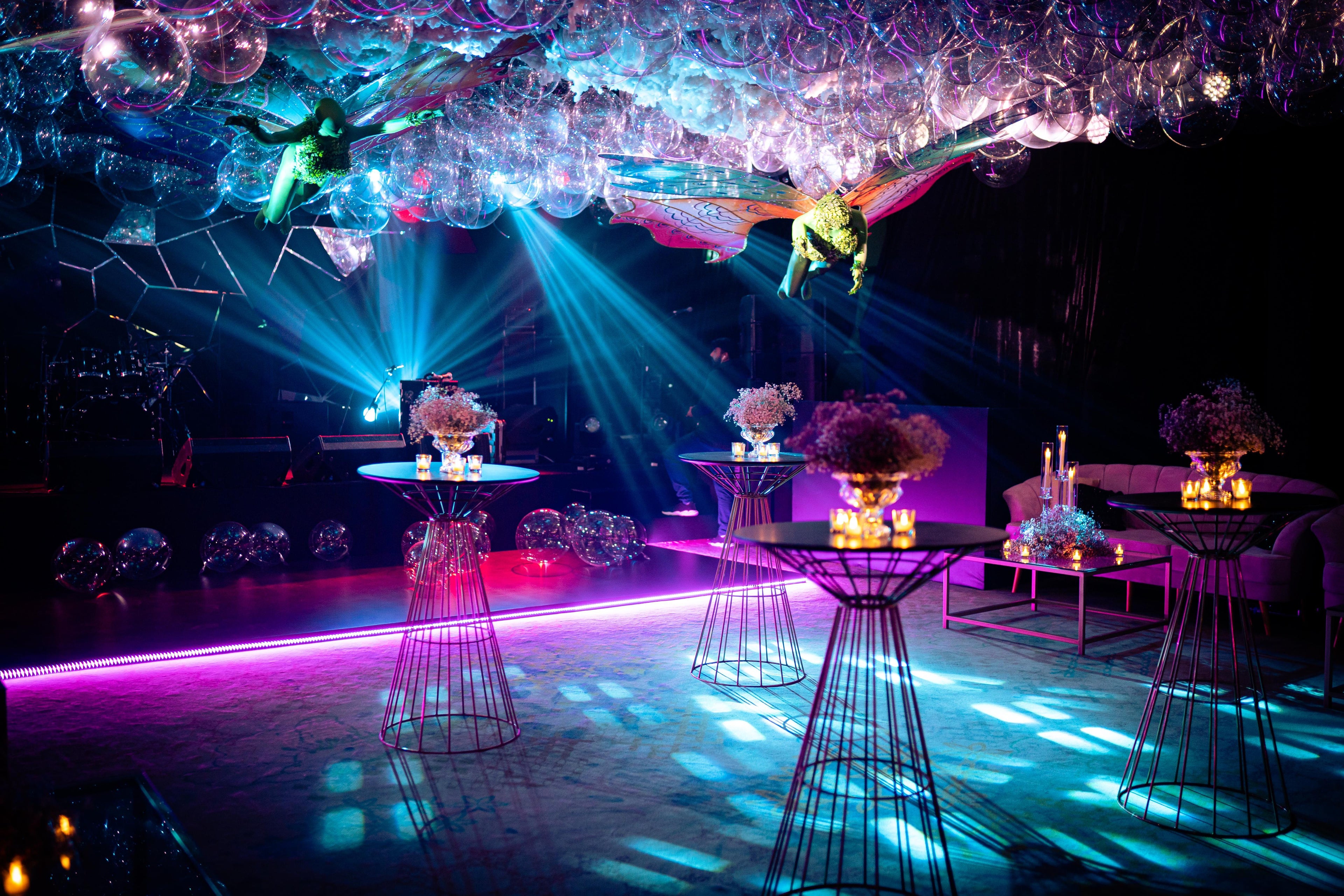 A beautiful room filled with balloons and floating fairies and extravagant lighting